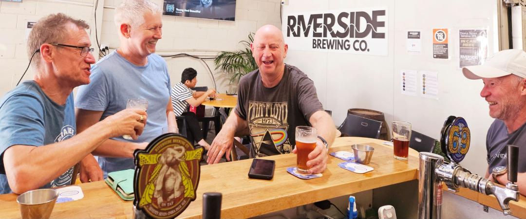 Men at Riverside Brewing bar