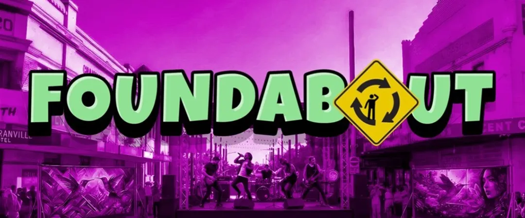 Purple-toned cityscape with neon text "FOUNDABOUT" in bold letters across the center, evoking a modern and vibrant urban vibe.