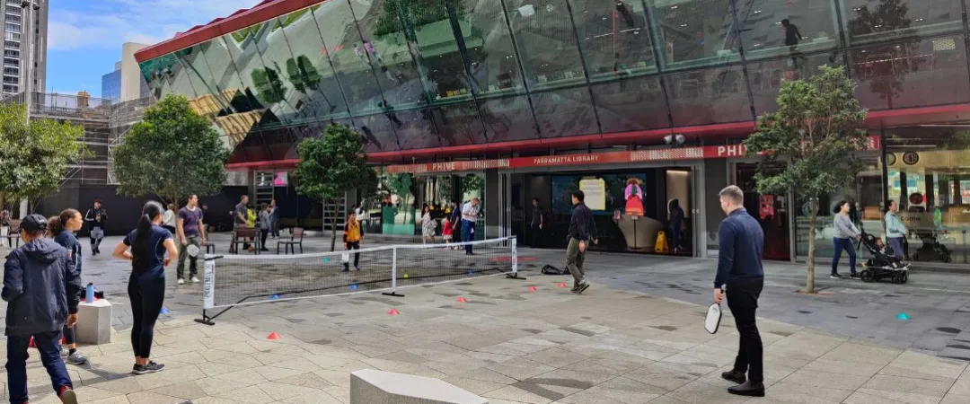 Men and women playing pickleball