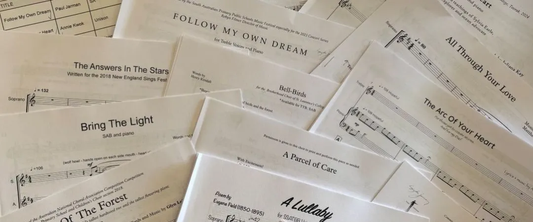 A collection of overlapping sheet music pages with various song titles such as "Deep Blue Heart" and "Follow My Own Dream," creating a creative and musical ambiance.