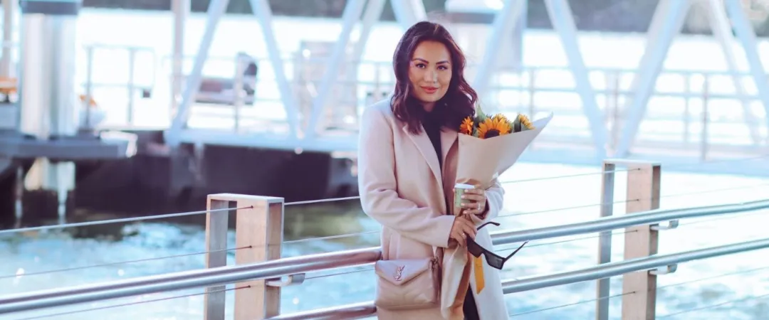 woman holding bunch of sunflowers from florist
