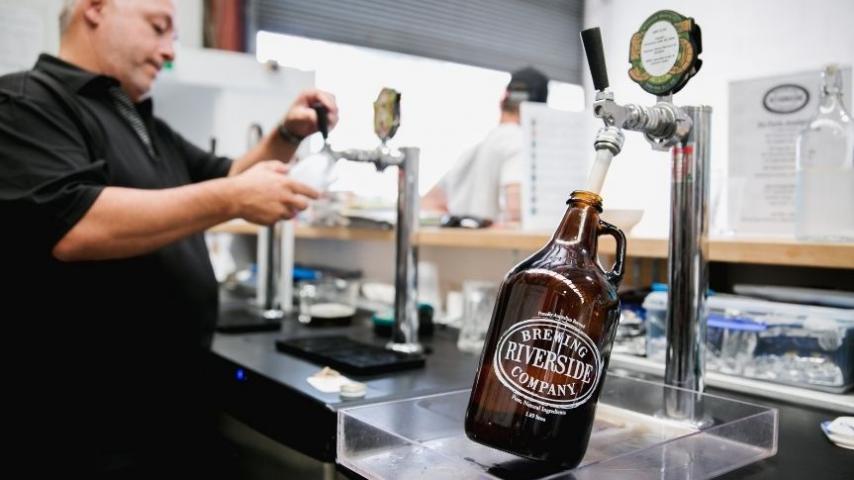 bartender pouring beer into a keg