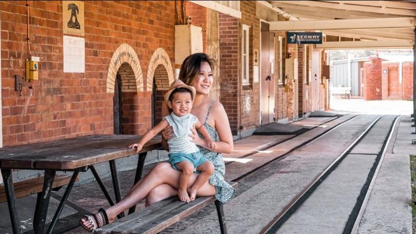 mother and young son at next to railway track