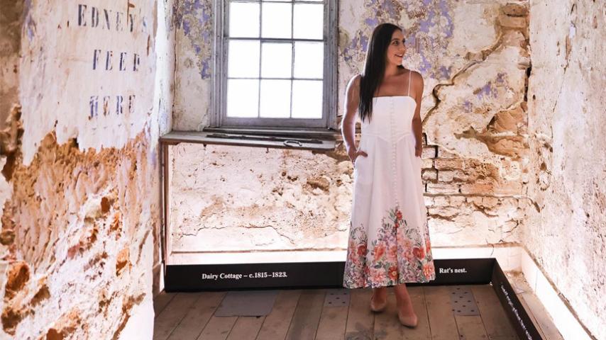 woman walking through hallway of old property