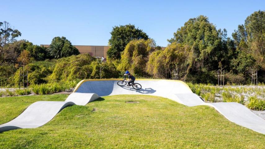 Kid riding bike on BMX pump track