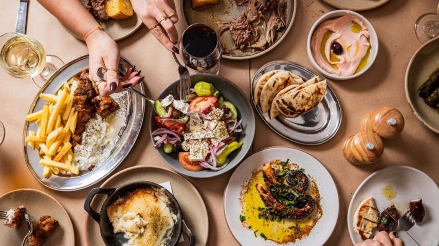 Table of chips, lamb shanks, hummus and chips