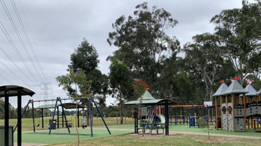 play equipment surrounded by trees in the park